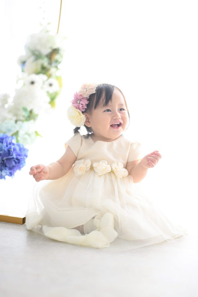 頭にお花の飾りを付けて嬉しそうな女の子